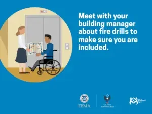 A person in a wheelchair discusses fire escape plans with a building manager, highlighting the importance of inclusive emergency procedures.